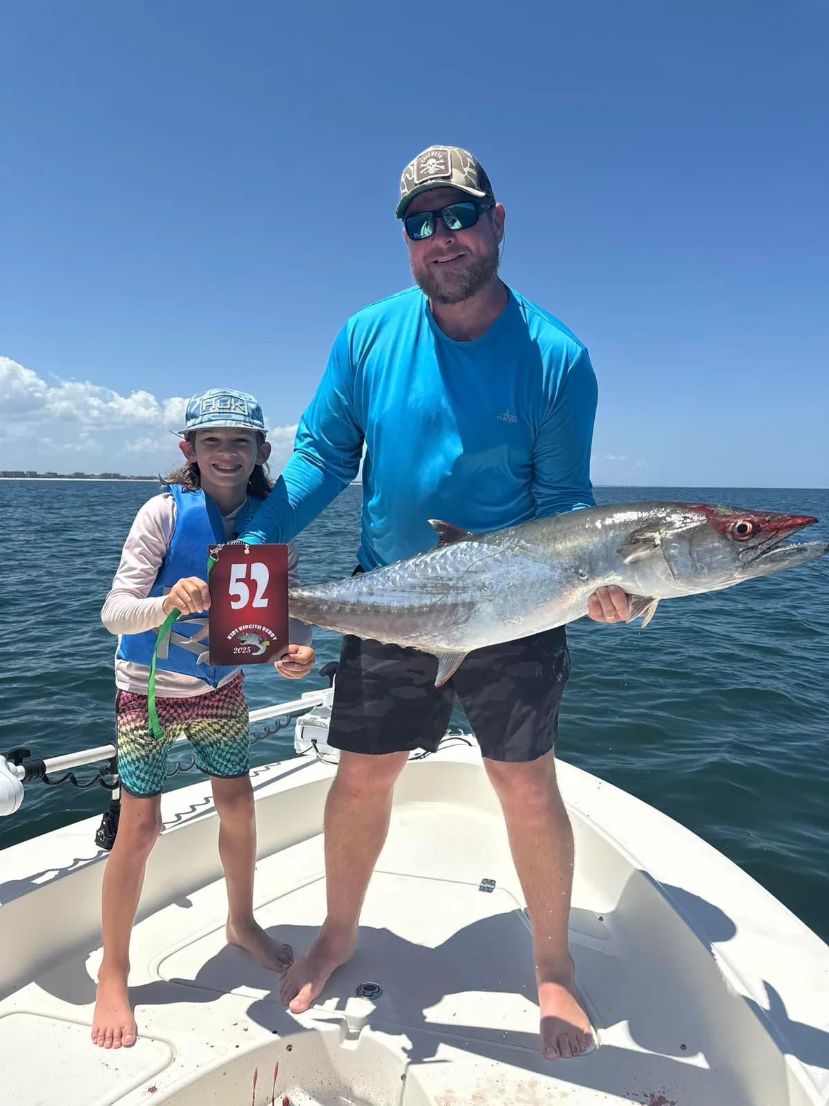 Young angler proudly holding a Kingfish at the Kids Kingfish Derby