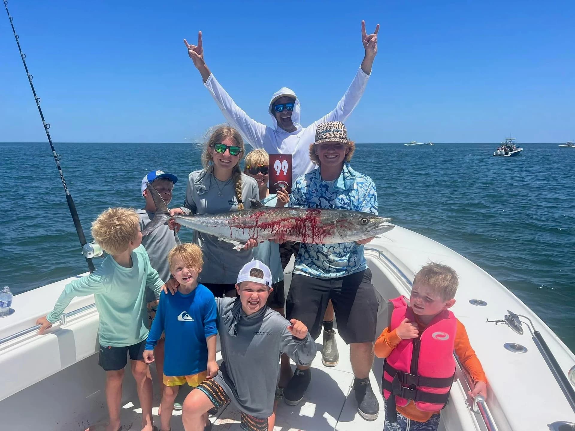 Kids holding a Kingfish on the boat at the Kids Kingfish Derby